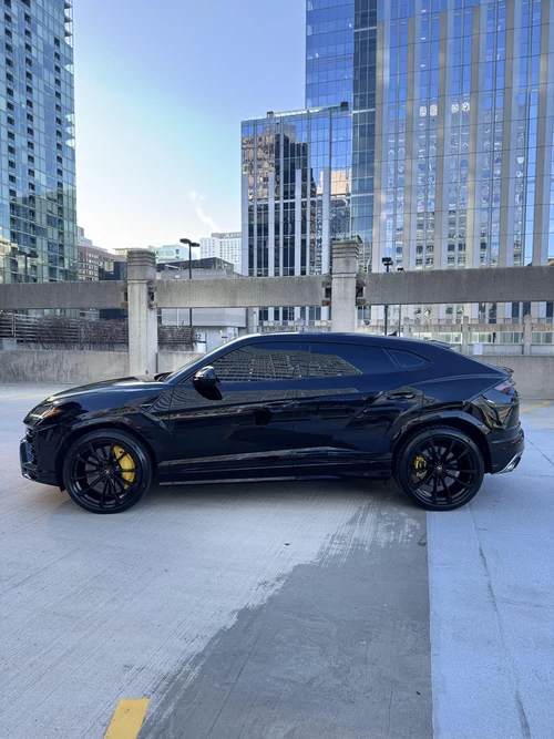 Lamborghini Urus - Black with Yellow Accents exterior side view — Axel Luxury Chicago