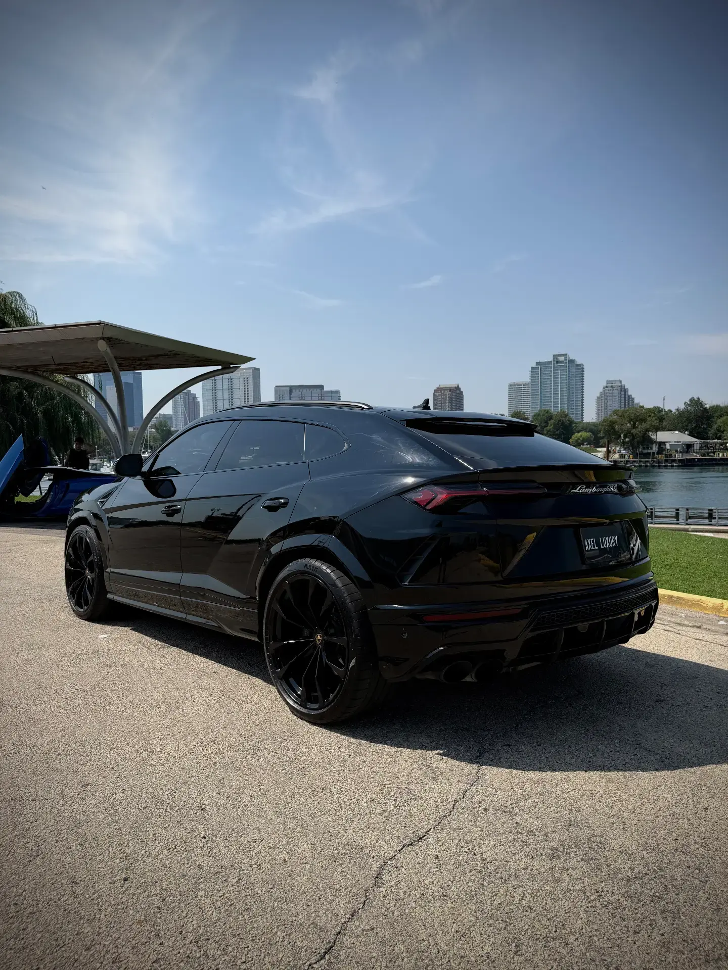 Lamborghini Urus - Black with Red Interior exterior rear 3/4 view — Axel Luxury Chicago