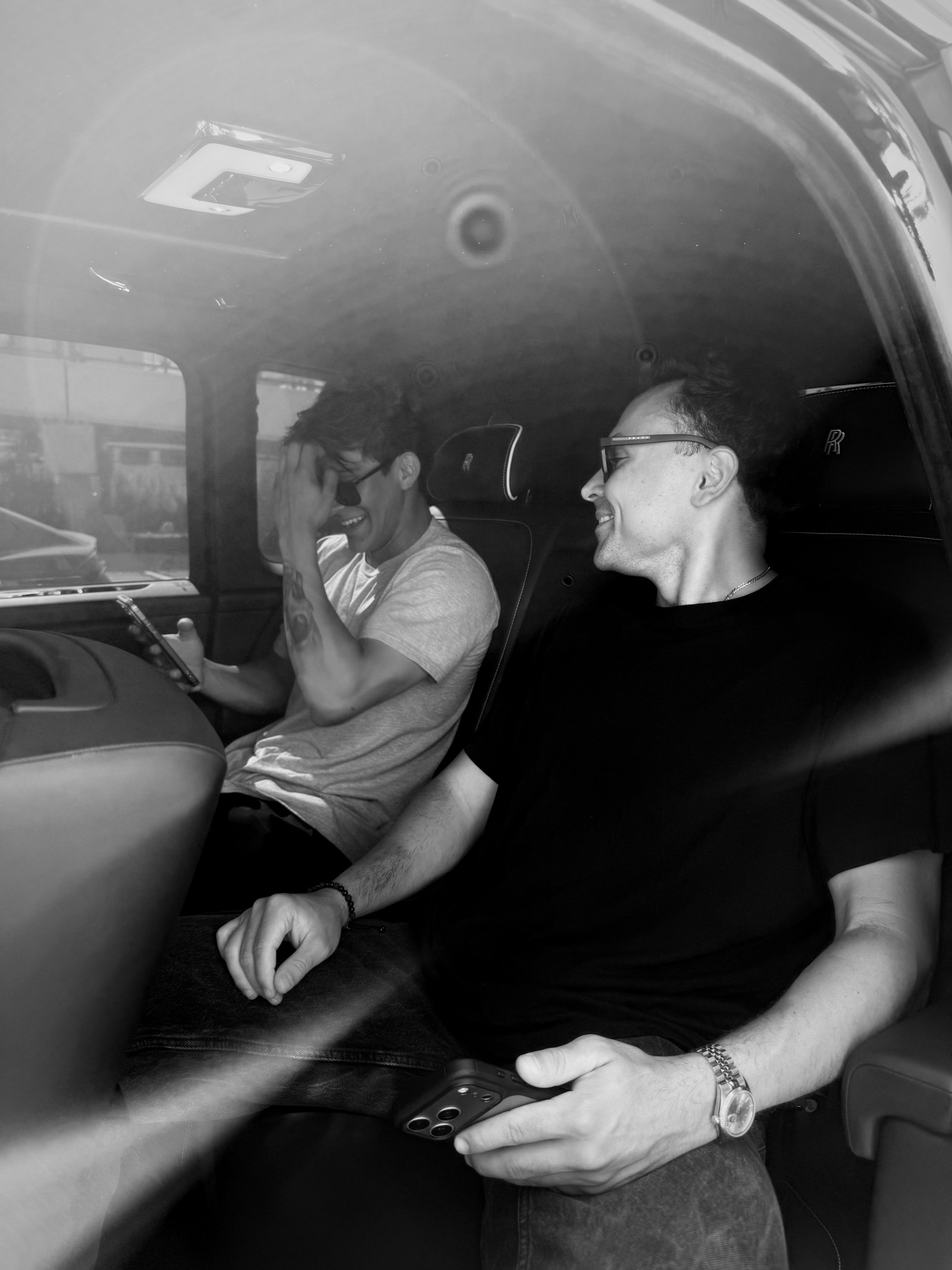 Axel Luxury founders Alejandro Sanchez and Kyle Barrera in the back seat of a Rolls-Royce Cullinan